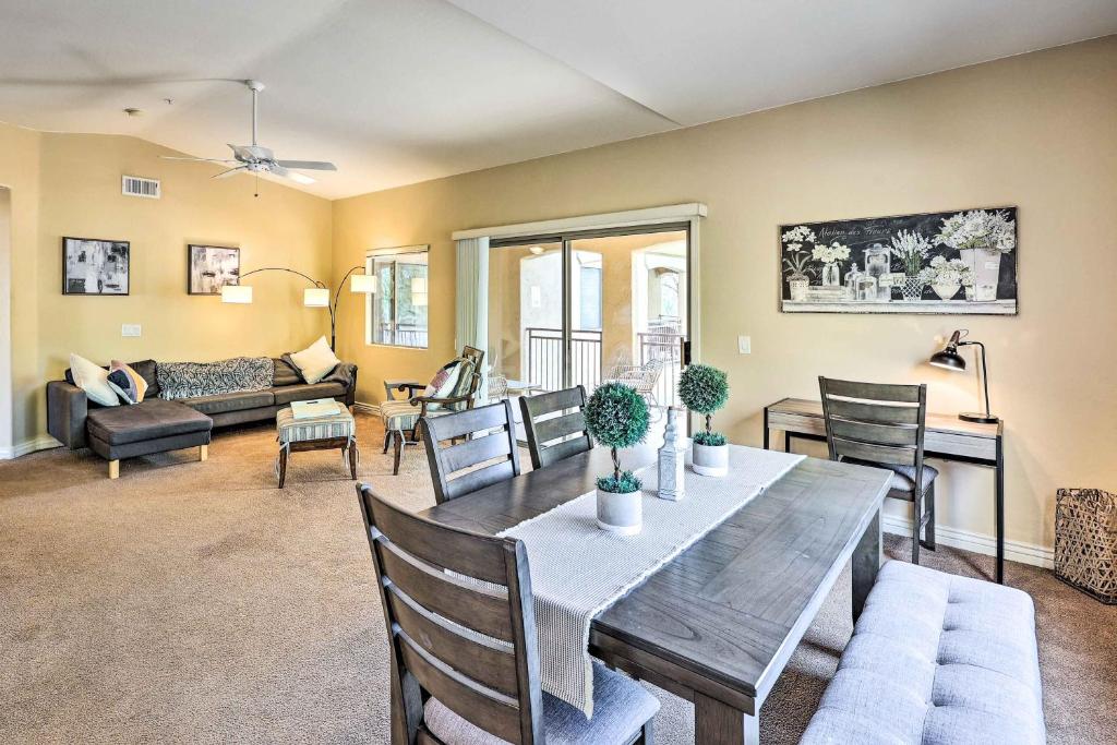 a dining room and living room with a table and chairs at Pet-Friendly Scottsdale Condo with Pool Access! in Scottsdale