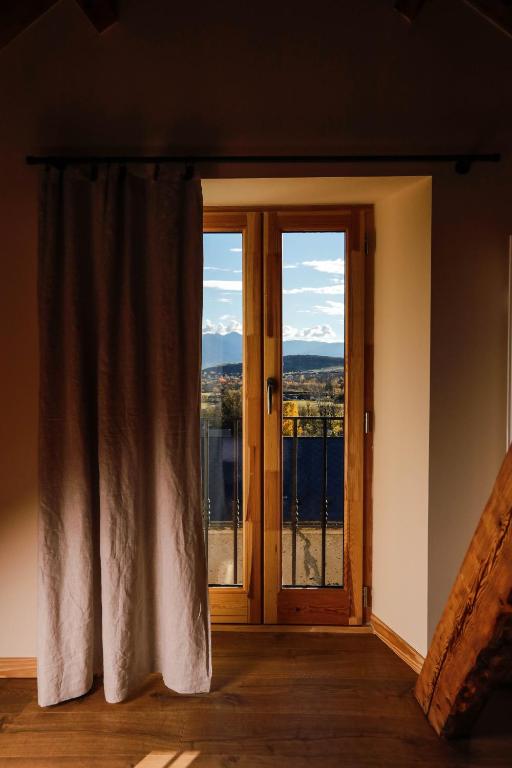 a room with a door and a window with a view at Domaine Agricole Cotzé &#47; Casa rural in Enveitg