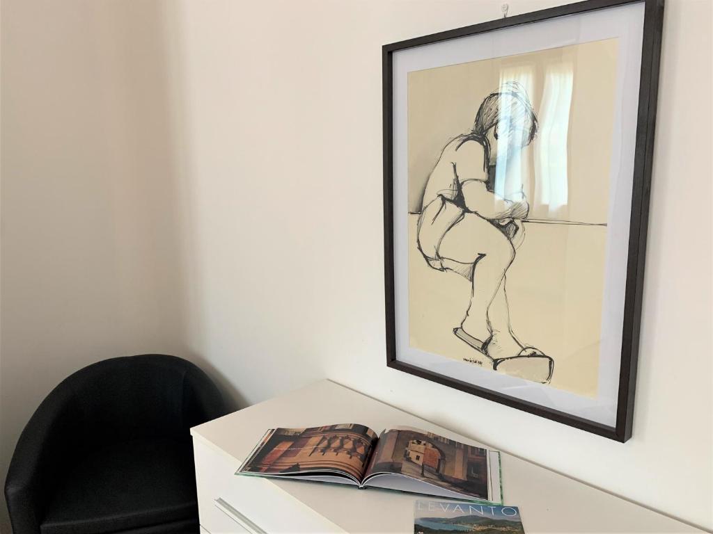 een tekening van een vrouw op een bureau met een boek bij Lella appartamenti con parcheggio in Levanto