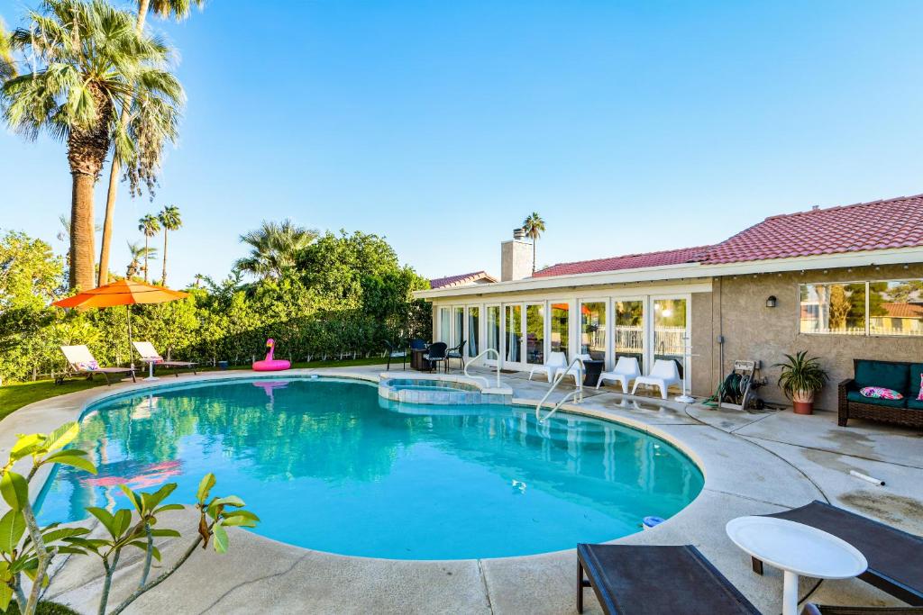 a swimming pool in the backyard of a house at Desert Pool House: Sun, Swim, Sip & Stay in Indio