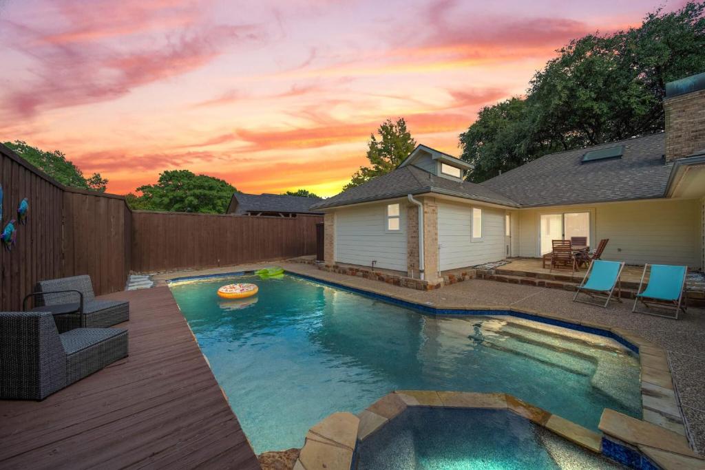 a swimming pool in the backyard of a house at Central Plano 4-BD 2-BA Pool Retreat, Sleeps 10 in Plano