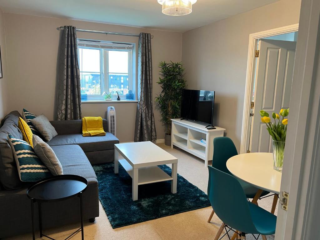 a living room with a couch and a table at Summerville in Kent