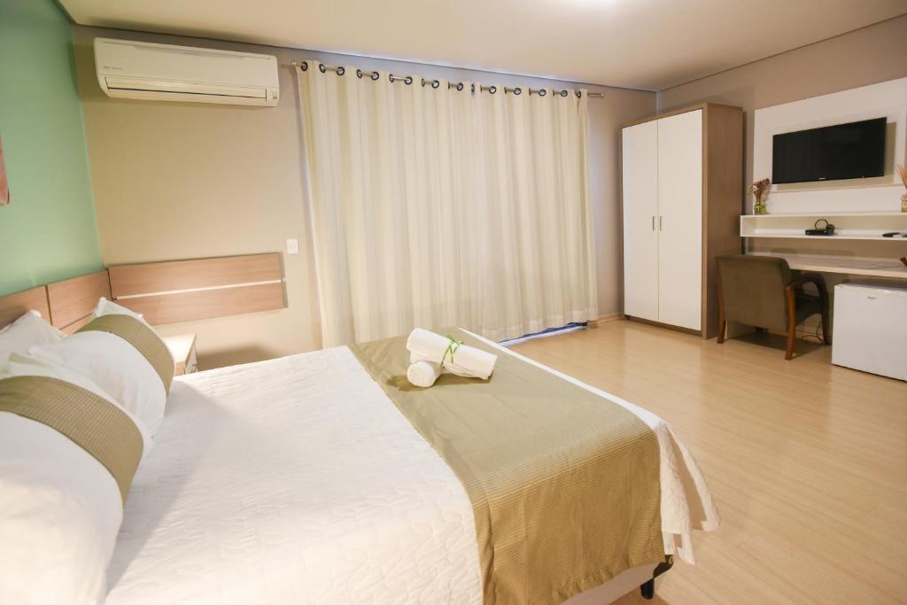 Postel nebo postele na pokoji v ubytování Pousada Três Pinheiros