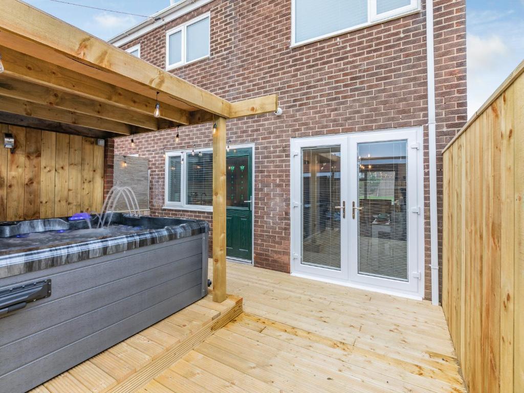 a patio with a sink and a wooden deck at Druridge Hideout in Broomhill