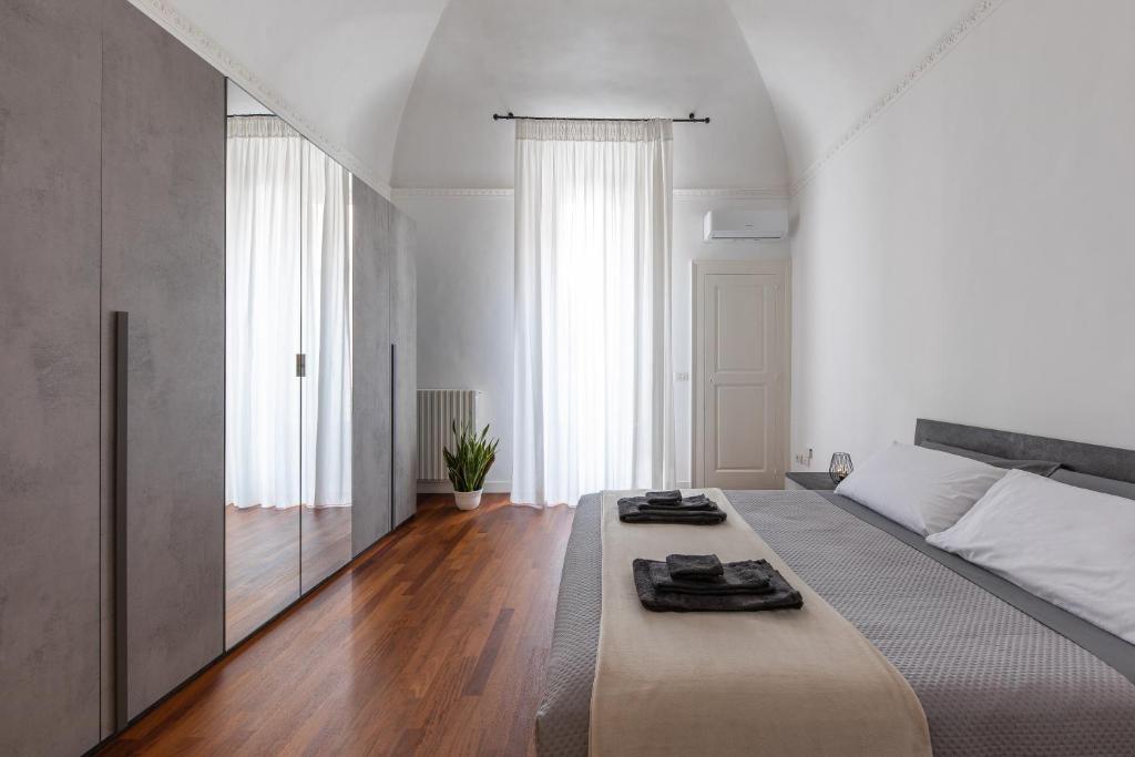 a bedroom with a large bed with a large mirror at Casa dei Visionari in Bari
