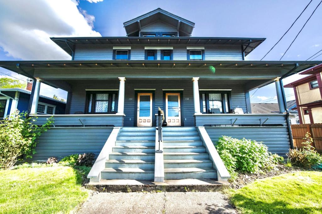 a blue house with stairs leading to the front door at Downtown Boho Revival Home PNW in Albany