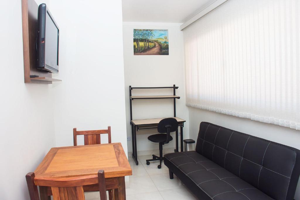 a living room with a couch and a table at Otimo apto c WiFi - Monte Castelo, Campo Grande MS in Campo Grande
