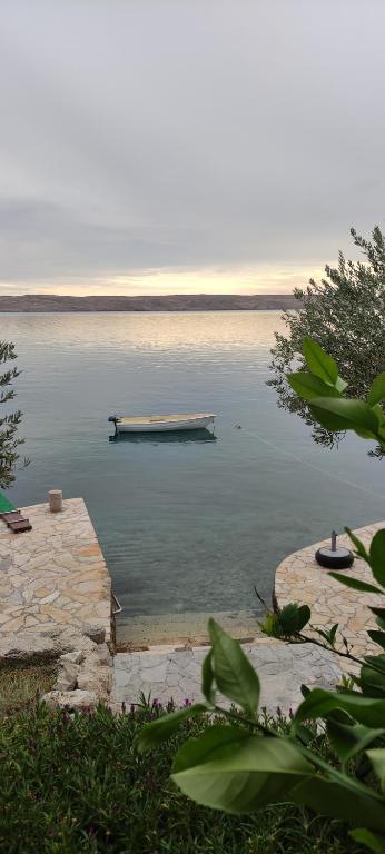 a dock in the middle of a body of water at Apartman JURJEVIĆ in Barić Draga