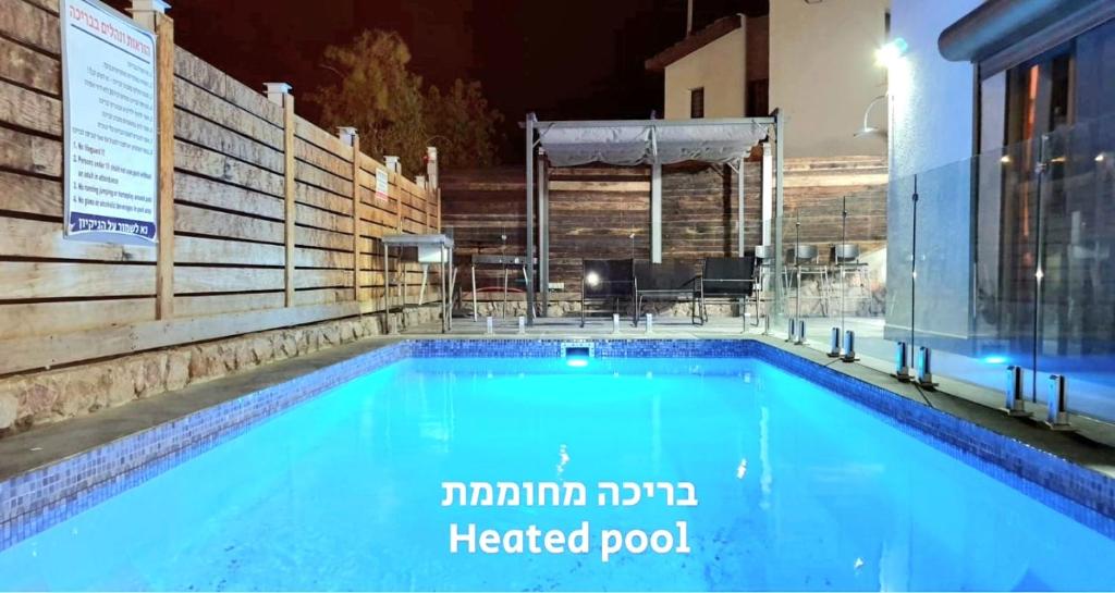 a swimming pool at night with a heated pool at VILLA SITVANiT- וילה סיתוונית by barak royal suites in Eilat