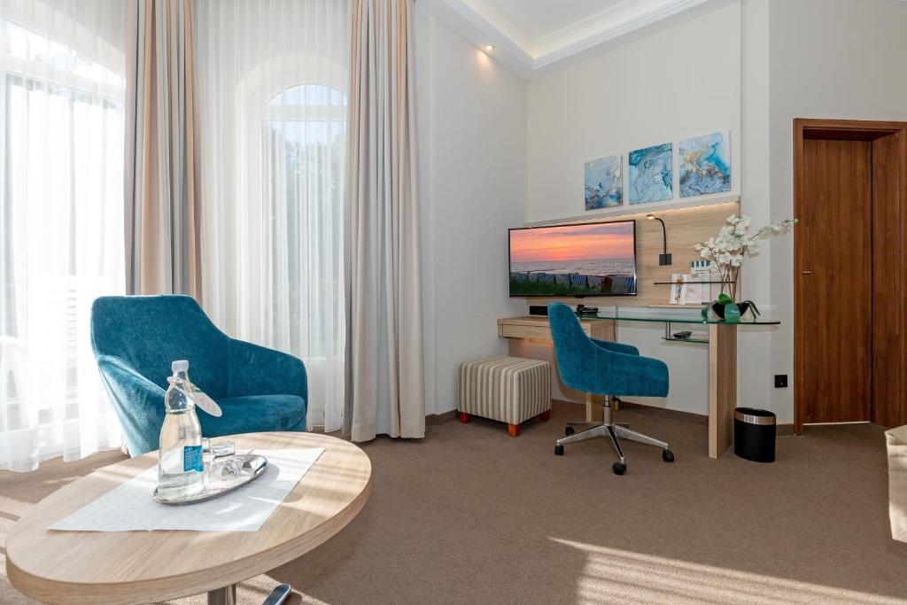 TV a/nebo společenská místnost v ubytování HOTEL am STRAND