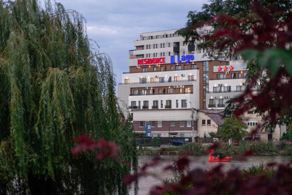 a large white building with a sign on it at Residence iL Lago in Cluj-Napoca