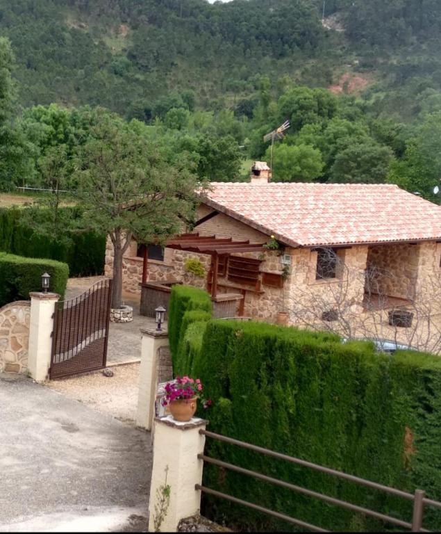a stone house with a fence in front of it at Casas Rurales Majana 1 in Riópar