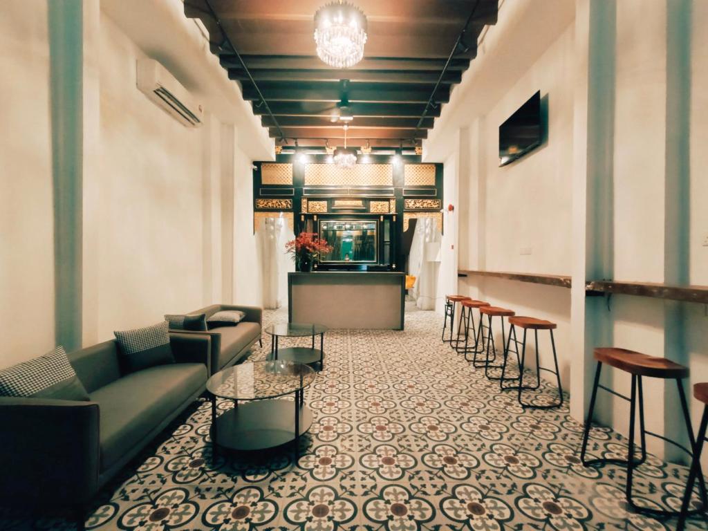 a lobby with a couch and chairs and a bar at The Magazine Boutique Hotel in George Town