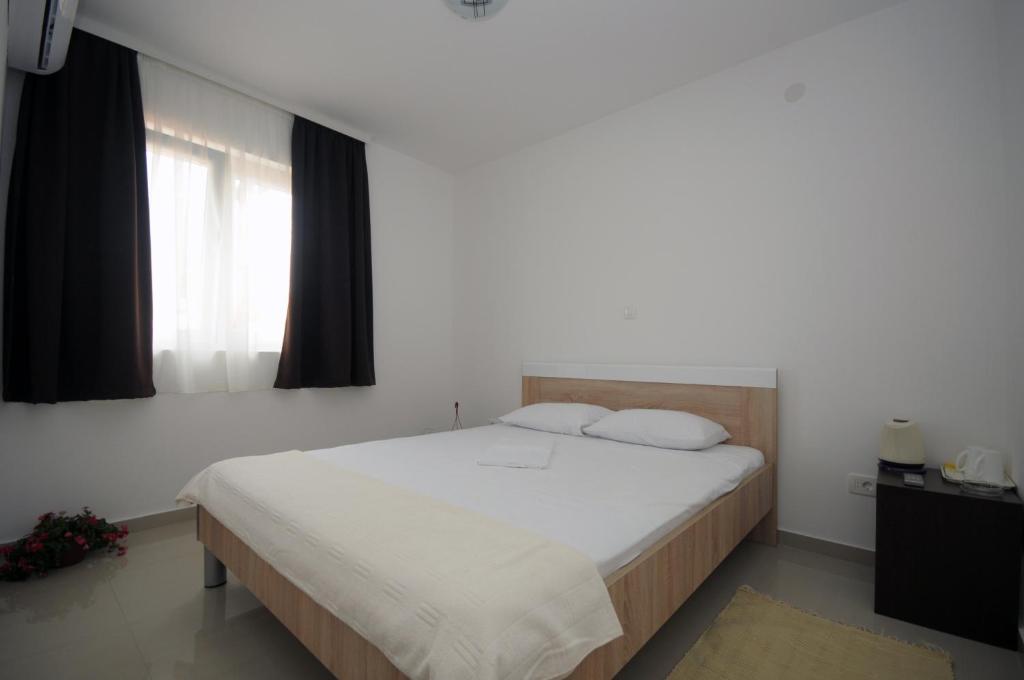 Postel nebo postele na pokoji v ubytování Apartments Vila Anastasia