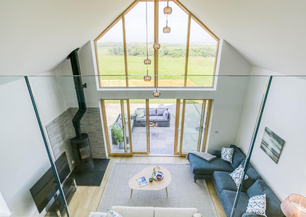 an overhead view of a living room with a large window at Bwncath & Hebog in Llanrhwydrys