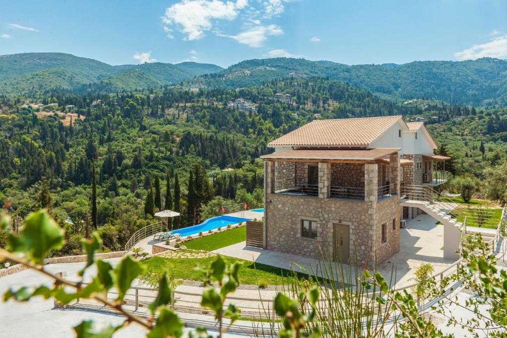an aerial view of a villa with a swimming pool at Milos Mountain - Villa Nikitas in Agios Nikitas
