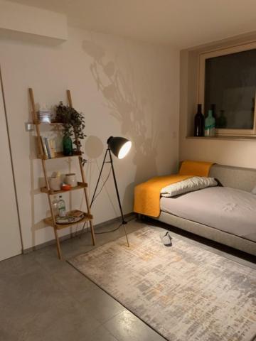 a bedroom with a bed and a lamp and a rug at Privatzimmer 500 m zur Messe München in Haar