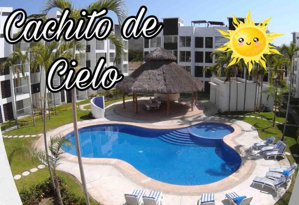 un hotel con piscina e la scritta cafeteria de caffe di CACHITO DE CIELO, Departamento de lujo 2 habitaciones y alberca a Manzanillo
