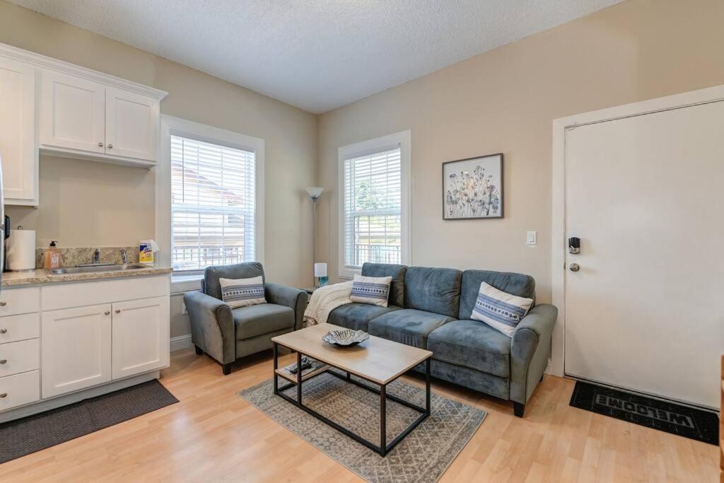 a living room with a couch and a table at Comfortable 2BR Spacious Deck! 7 mins to Sacramento Downtown and Midtown in Sacramento