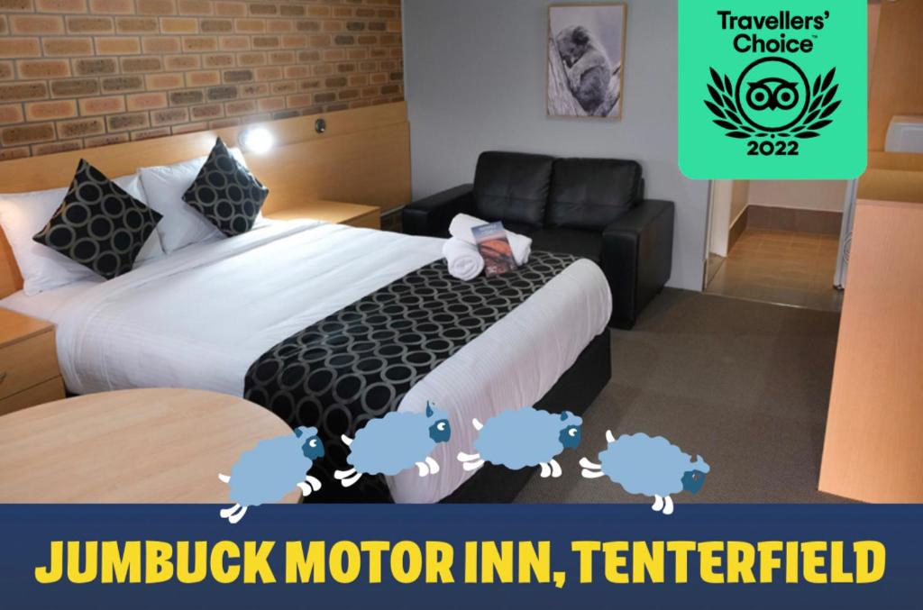 a hotel room with a bed and a couch at Jumbuck Motor Inn in Tenterfield