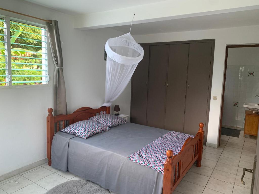 a bedroom with a bed and a window at Logement vacances Gissac Sainte-Anne in Sainte-Anne