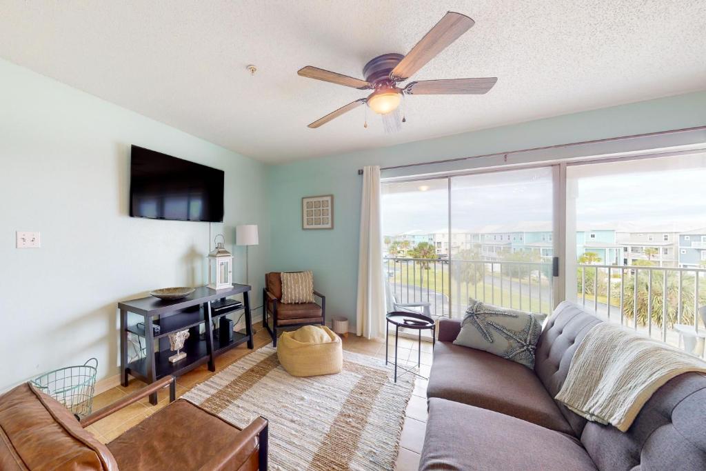 a living room with a couch and a ceiling fan at Sunset Harbour Villas 3-332 in Navarre