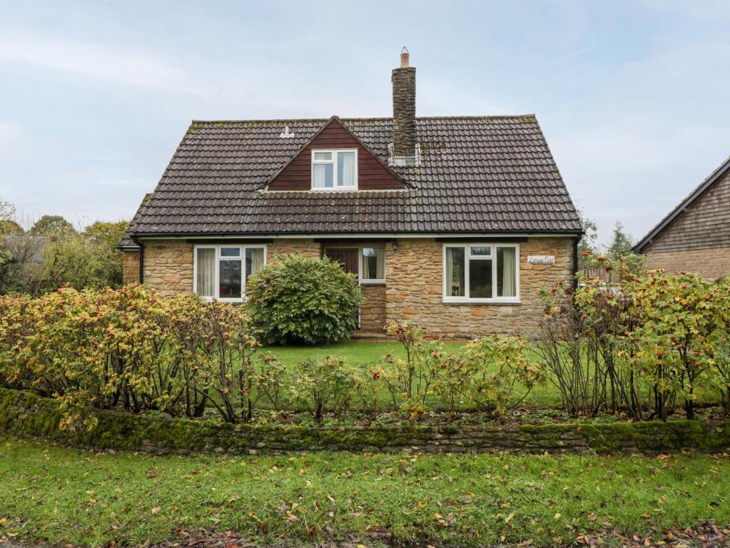 a brick house with a black roof at Lanes End in Sherborne