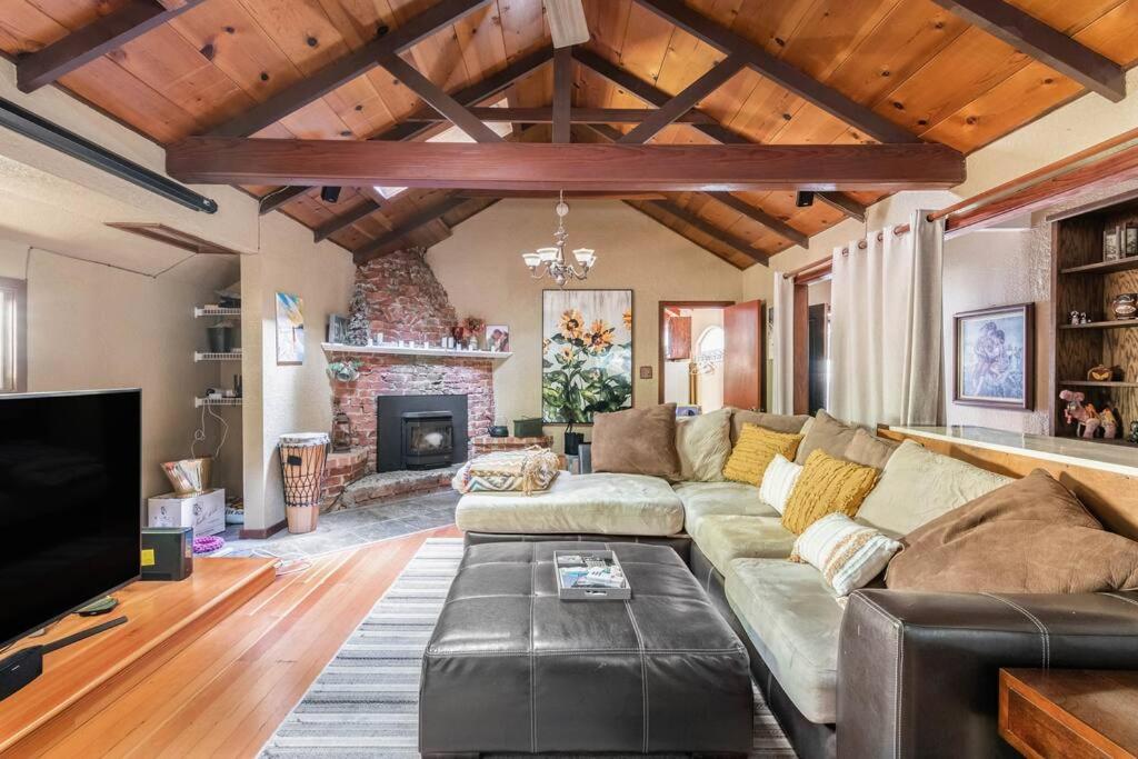a living room with a couch and a fireplace at Tranquil creek mountain house in Los Gatos