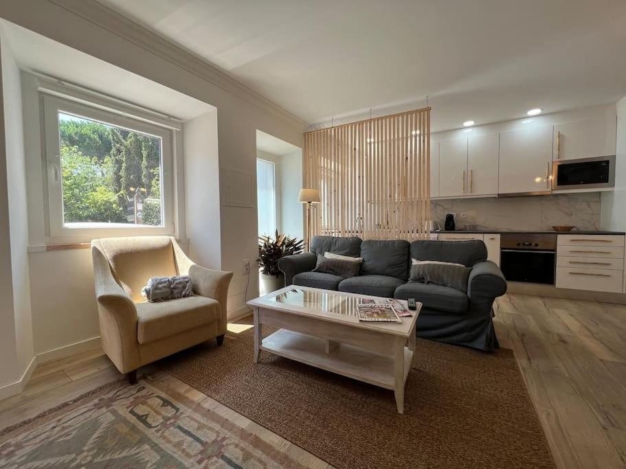 a living room with a couch and a table at Casinha de santo Antonio in Villa Nogueira