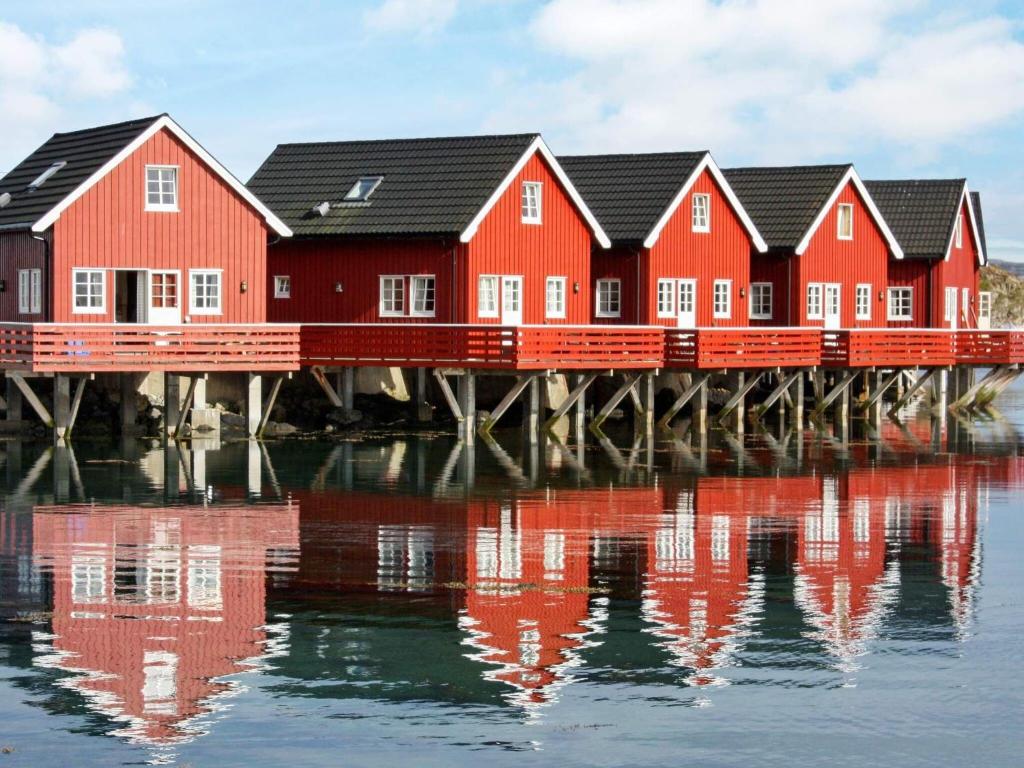 a row of red houses on a dock on the water at 6 person holiday home in Brekstad-By Traum in Brekstad