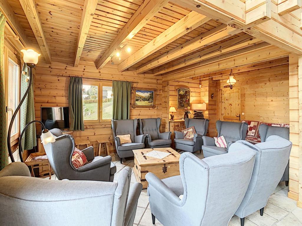 a living room with couches and chairs in a cabin at Chalet spacieux 13 couchages proche pistes à Demi-Quartier - FR-1-560-36 in Demi-Quartier