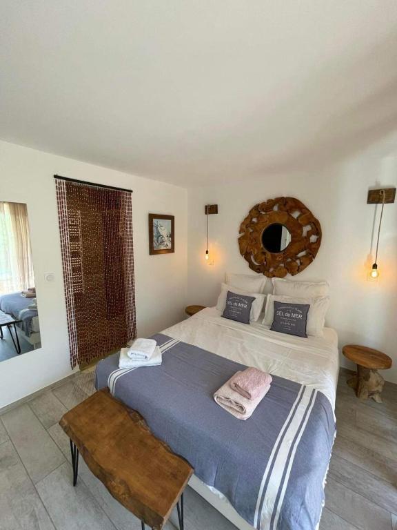 a bedroom with a large bed and a mirror at Maxima Sunset in Sainte-Maxime