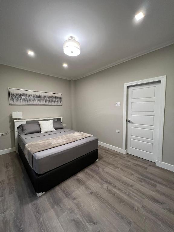 a bedroom with a bed and a white door at SHAK Condos- Luxury, Functionality and Comfort in Saint Helena