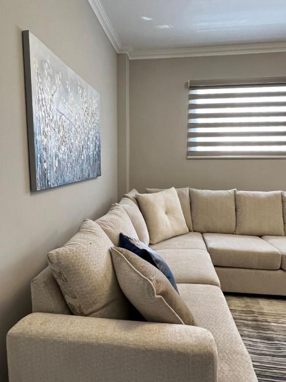a living room with a couch and a window at SHAK Condos- Luxury, Functionality and Comfort in Saint Helena