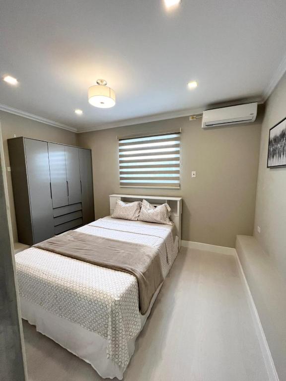 a bedroom with a large bed and a window at SHAK Condos- Luxury, Functionality and Comfort in Saint Helena