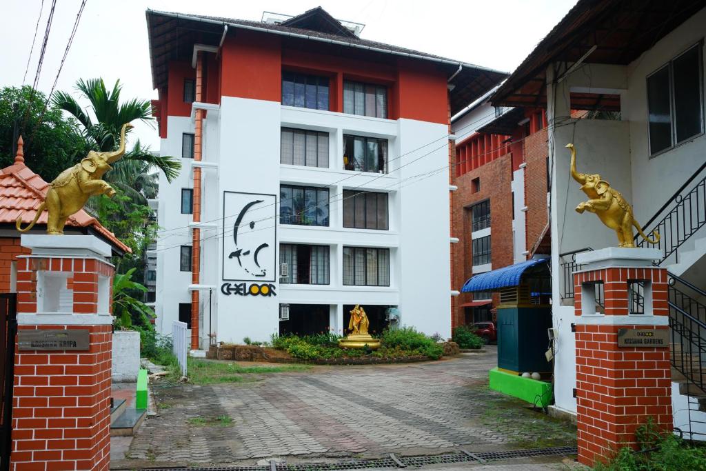 a building with a sign on the side of it at Vrindavan Suites Guruvayur in Guruvāyūr