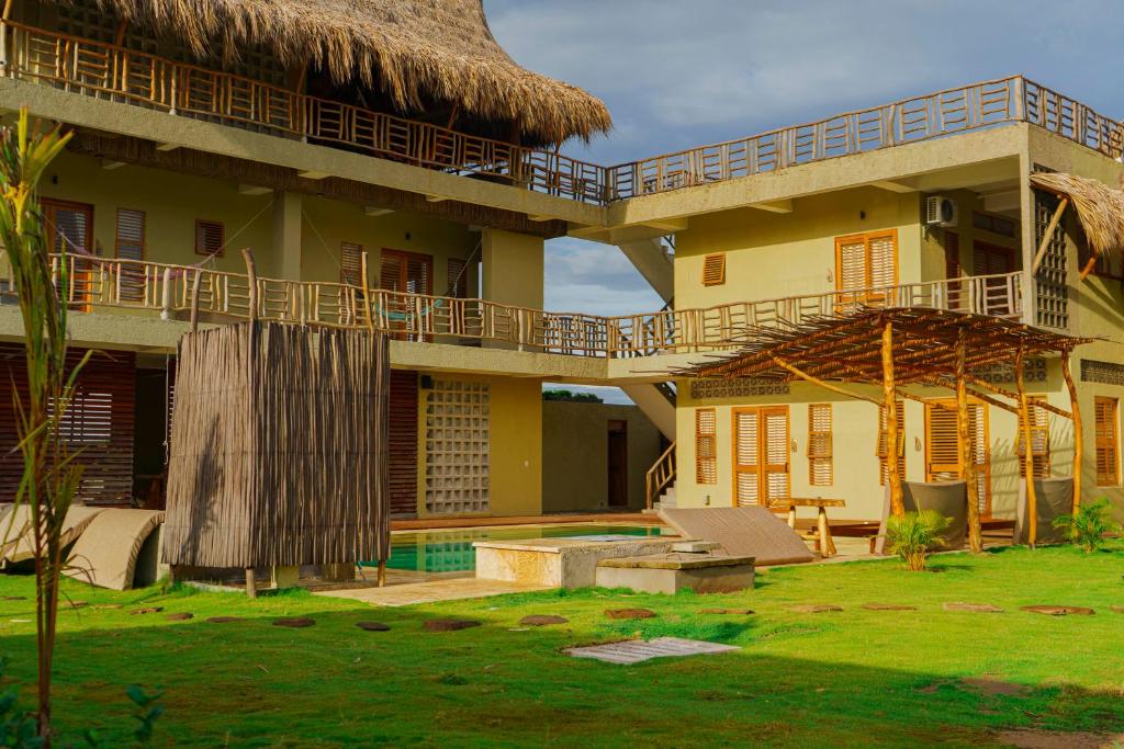 a resort with a pool and a building at Casa Mambo Salinas in Santa Veronica