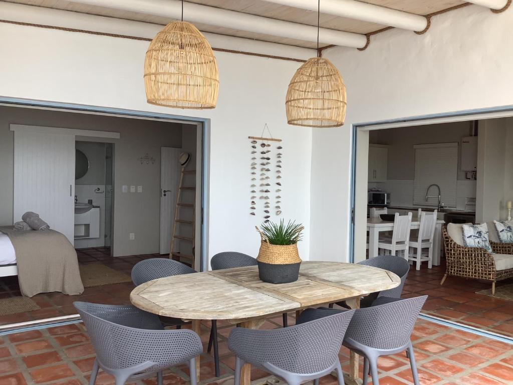 a dining room with a table and chairs at C'est la Vie in Paternoster