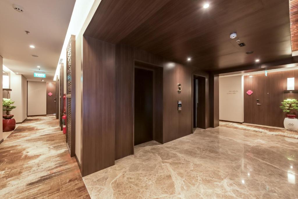 a hallway in a building with wooden walls at Ashley Tang Menteng Jakarta in Jakarta