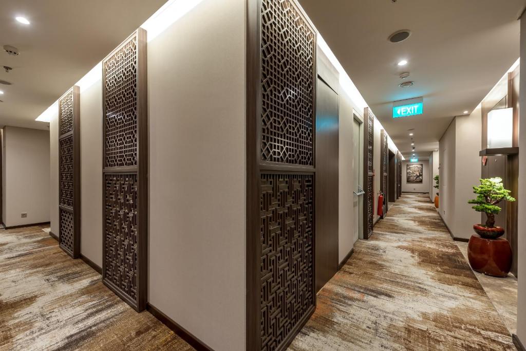 a corridor of a hospital hallway with a wall of doors at Ashley Tang Menteng Jakarta in Jakarta