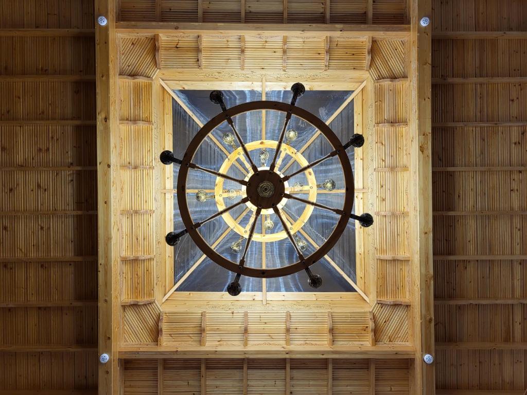 a window in a bamboo building with a clock in it at Ulli Oy Hotel & Terrace in Khiva