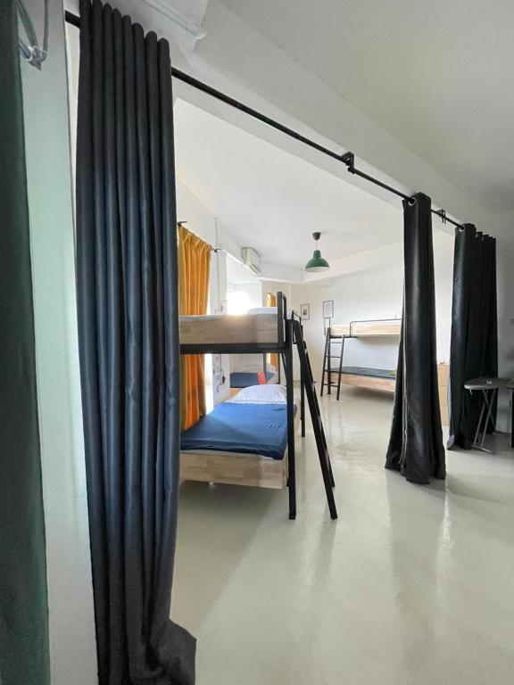 a bedroom with two bunk beds in a room at IM Santai Lodge in Kangar