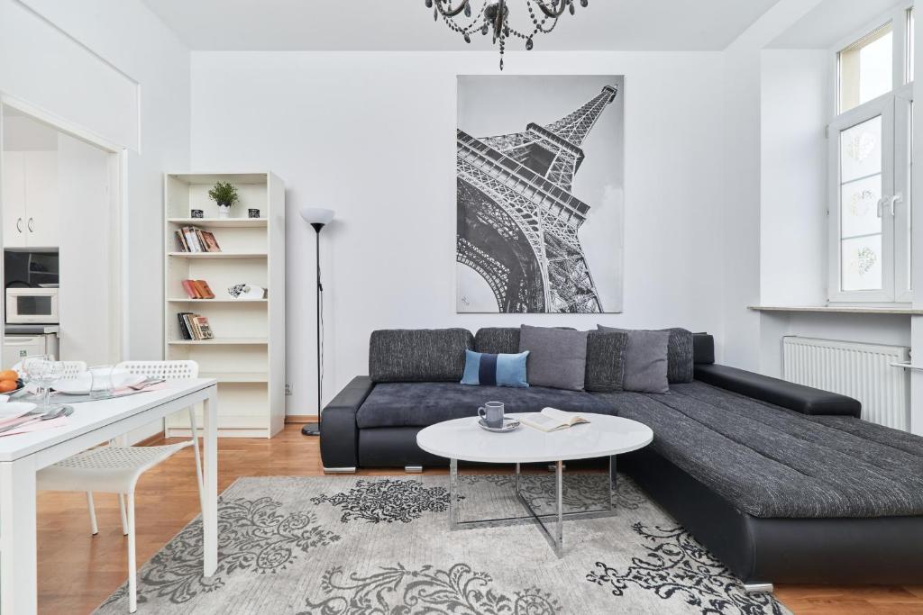 a living room with a couch and a table at Rynek Apartment The Heart of the City by Renters in Wrocław