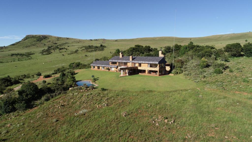 an aerial view of a large house on a hill at Amberley Mountain Reserve in Dullstroom