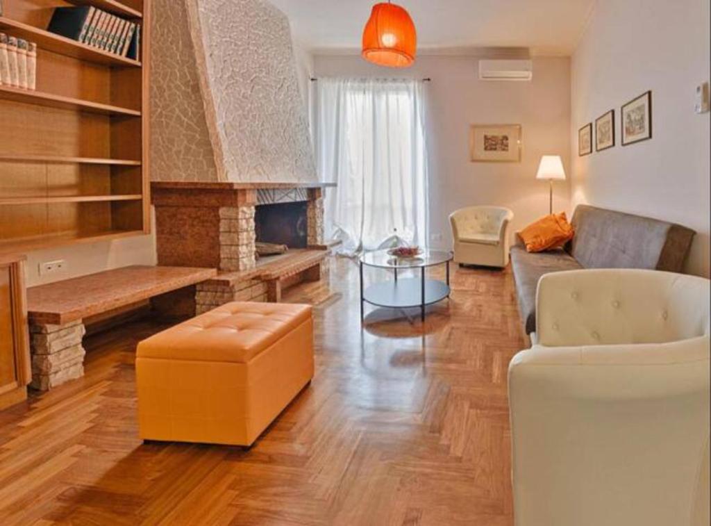 a living room with a couch and a fireplace at Key Apartment Vatican Wall in Rome