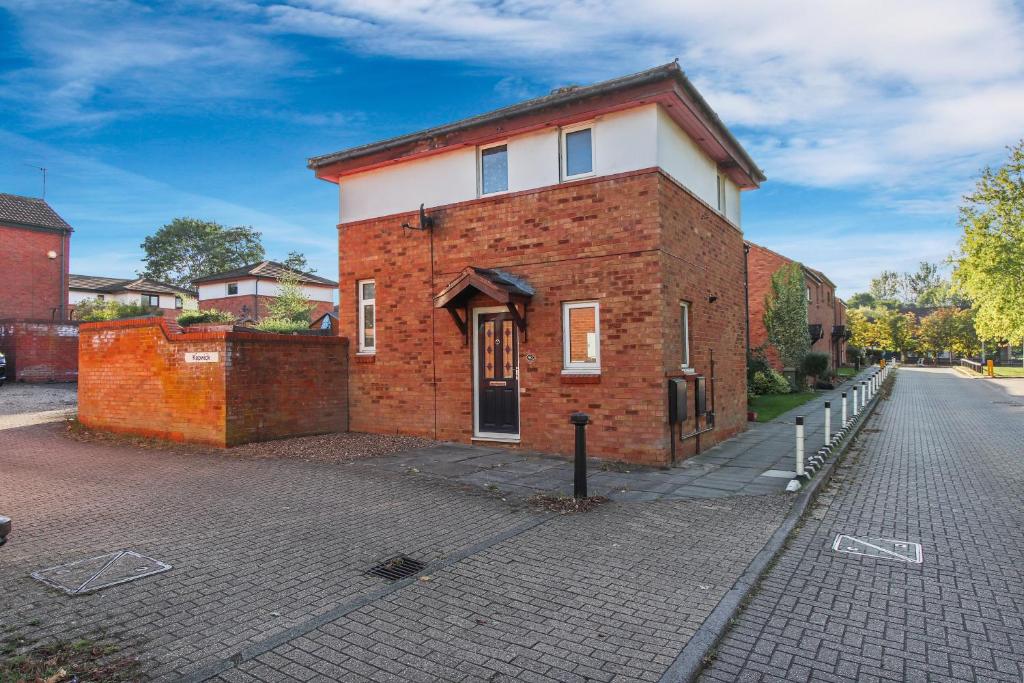 a brick building on the side of a street at Inviting 2-Bed House in Milton Keynes - Netflix in Milton Keynes