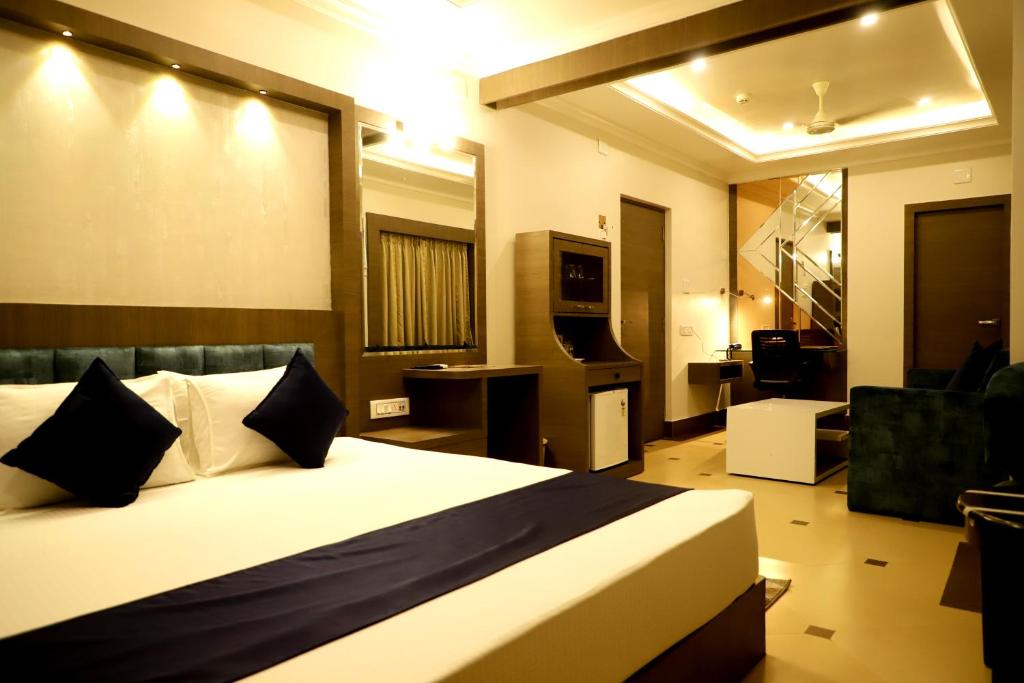 a hotel room with a bed and a living room at Hotel Avenue Plaza, Serampore - N S Avenue 