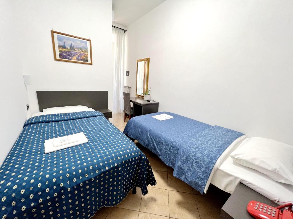 Postel nebo postele na pokoji v ubytování Hotel domus termini