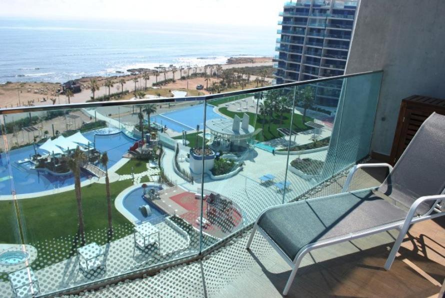 a balcony with a view of a pool and the ocean at Sea Senses Blue Ocean in Torrevieja