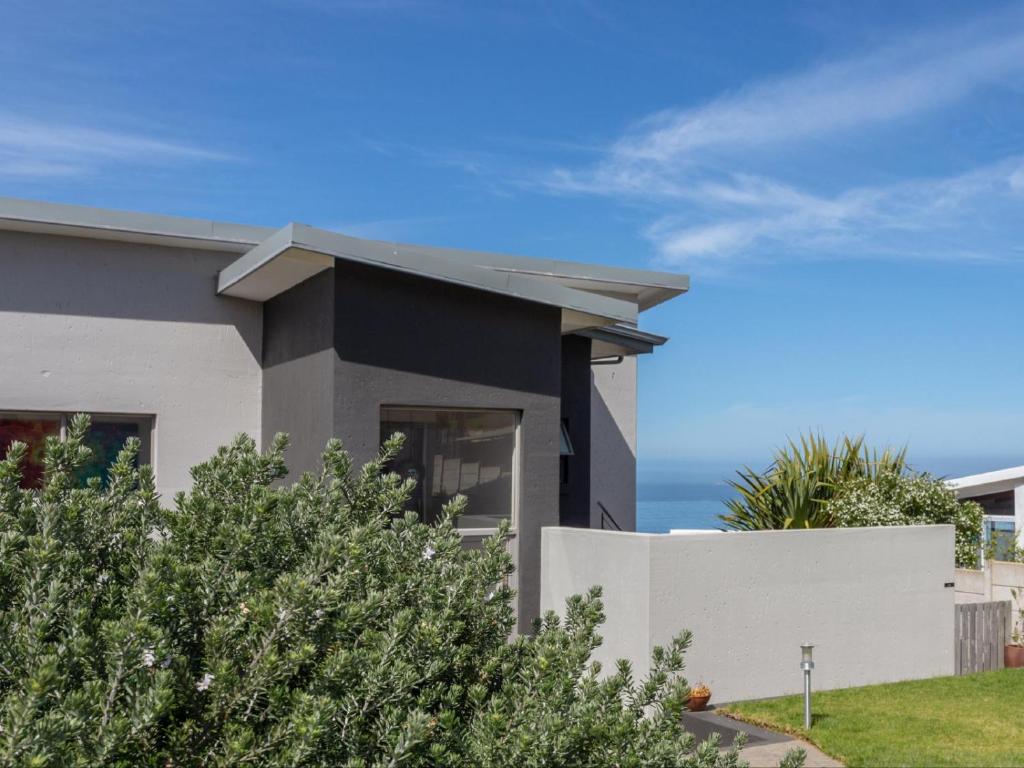 a house with the ocean in the background at Erika27 B&B NO LOADSHEDDING in Dana Bay